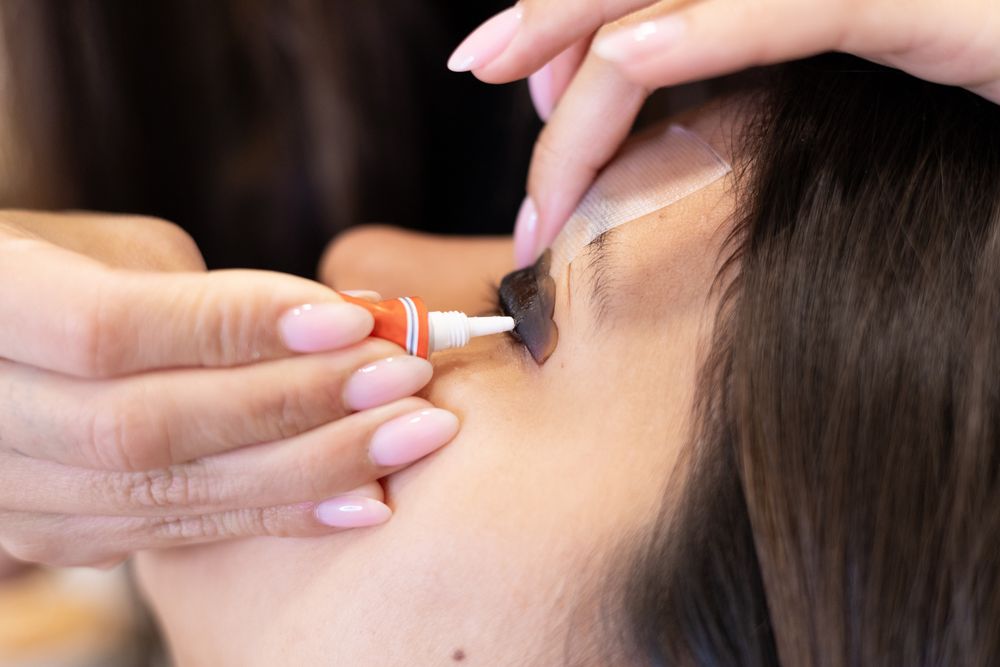 Beautician making eyelash lamination and dyeing procedures