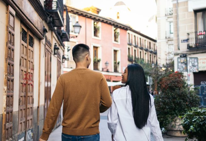 Interracial couple walking on the city street