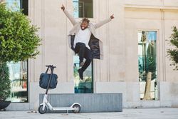 Excited Black male jumping on street