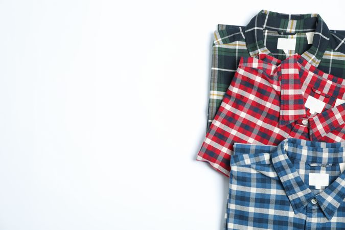 Flat lay with shirts on blank background, copy space