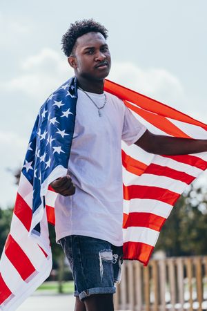 Black man with American Flag outside