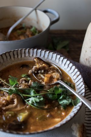 Bread and parsley near quinoa soup