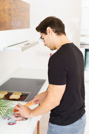 Man cooking in bright kitchen at home
