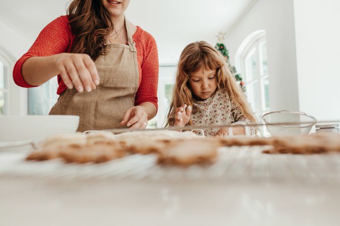 Woman and girl making Christmas cookies