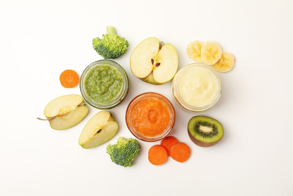 Composition with baby food on plain background. Vegetable puree