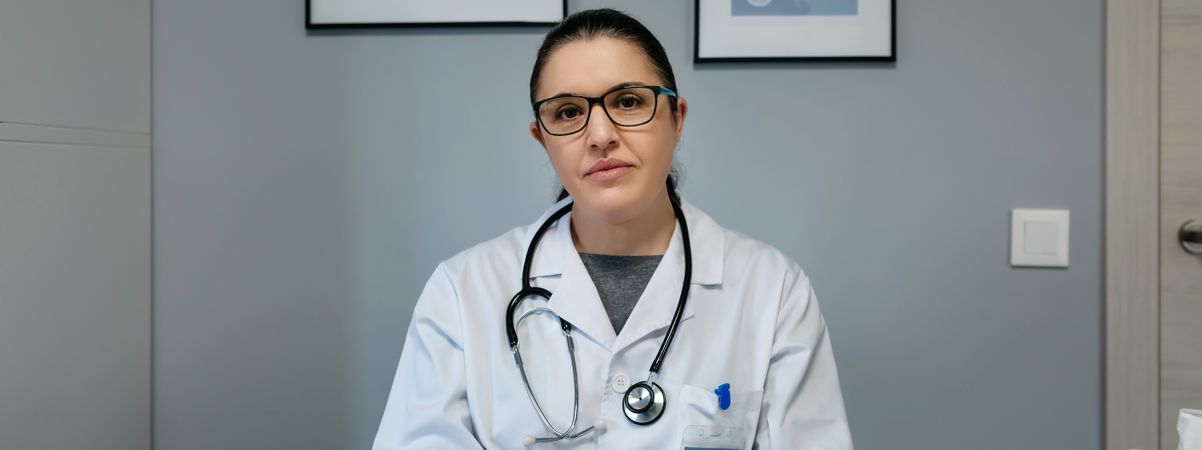 Female doctor looking at camera in her office