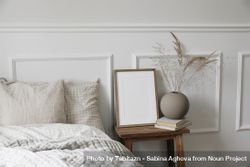 Bedside table with mockup poster, round vase with decorative reeds 4jPYx0