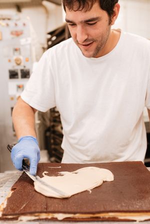 Anonymous pastry cook decorating sweet cake