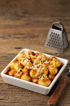Gnocchi with tomato sauce and grated Parmesan cheese.