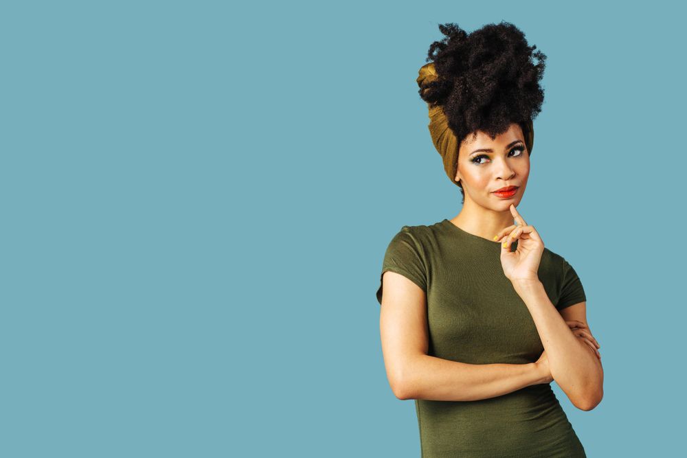 Studio shoot of curious Black woman on blue background