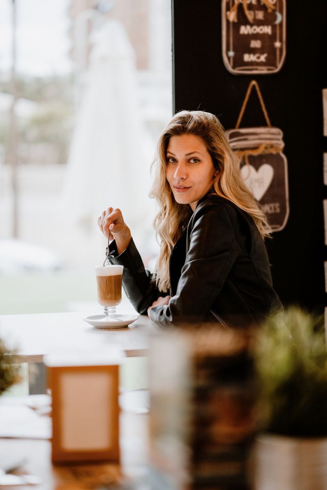 Woman drinking coffee from a glass