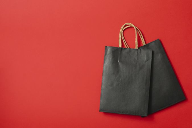 paper bags on red background, space for text