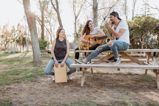Cheerful musicians having fun in park