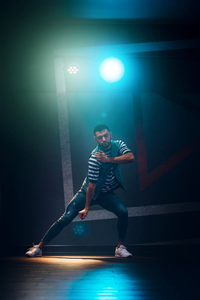 bearded man dancing in spotlight