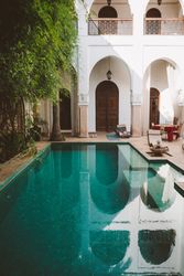 Tranquil resort pool in oriental patio