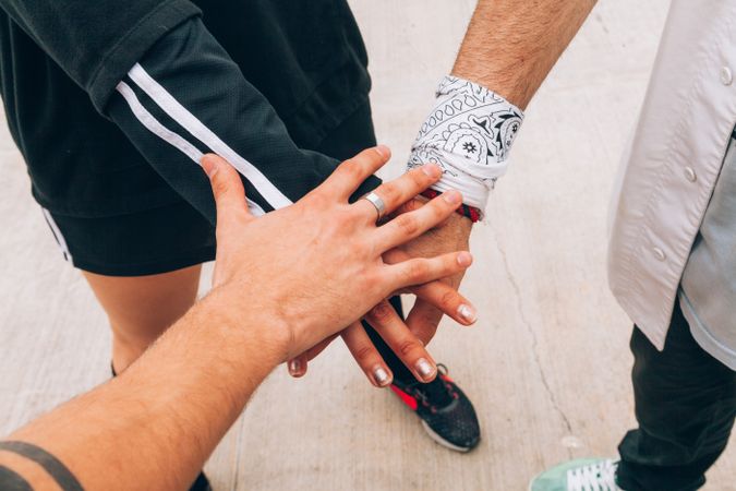 Group of young people putting hands together