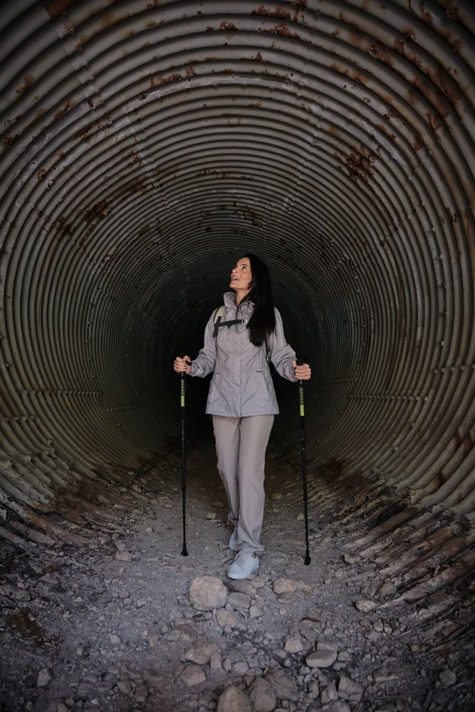 Active Hispanic woman in old tunnel