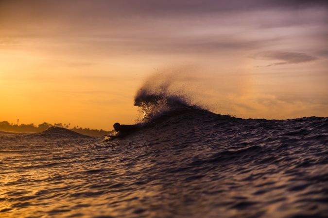 Man on surf board floating on wavy water
