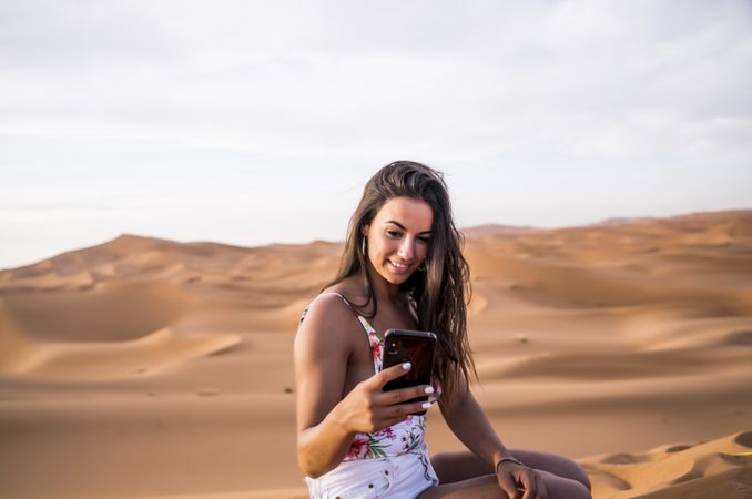 Woman taking selfie in desert