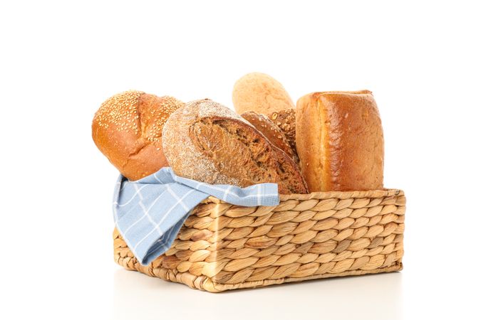 Bakery products in straw basket isolated on blank background