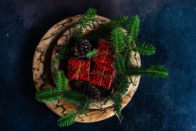 Holiday table setting with gift boxes and fir branches