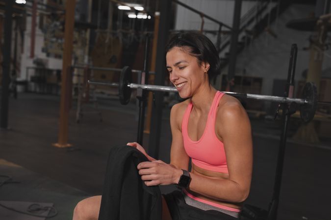 Athletic woman with towel in gym
