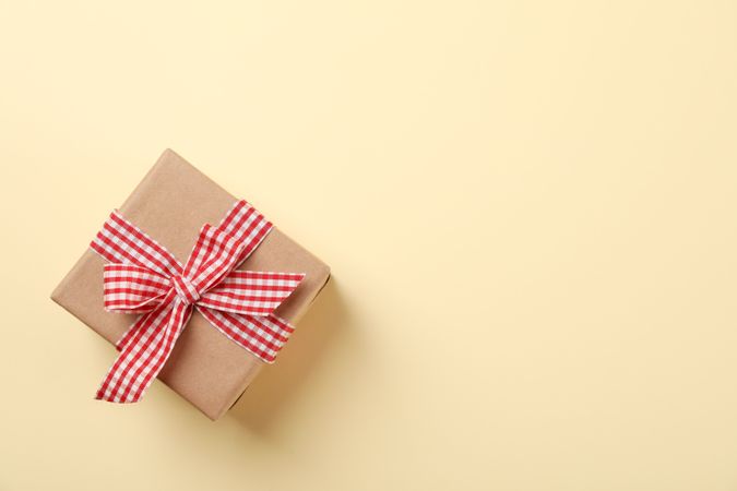 Gift box with bow on color background, space for text