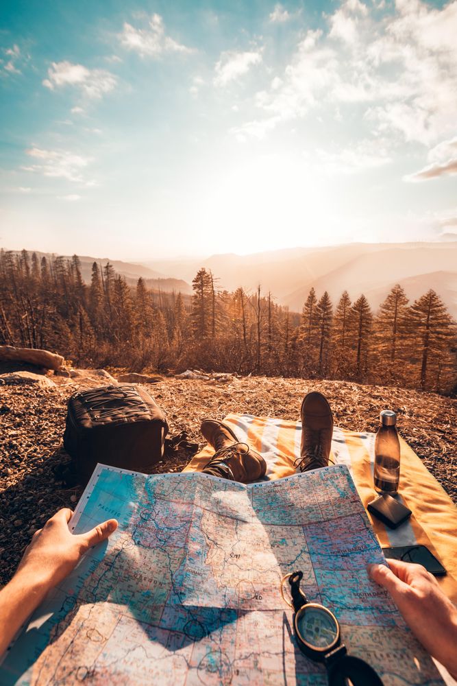 Man sitting on the ground with map on his lap