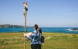 Couple looking a map and direction sign