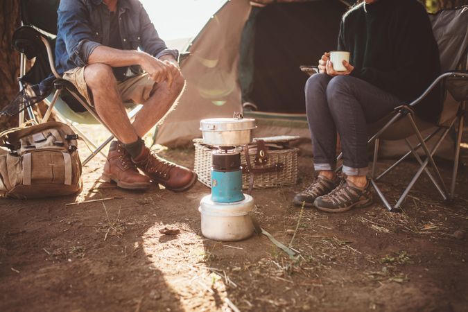 Cropped shot of mature couple sitting around a camp stove