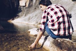 Woman on rock in beautiful lake