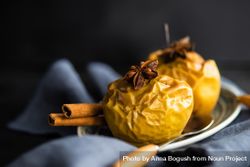 Plate of baked apple topped with star anise 0yKwO4