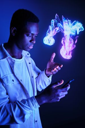 Serious Black man interacting with smartphone