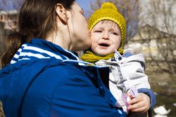 Woman comforting her crying child outside