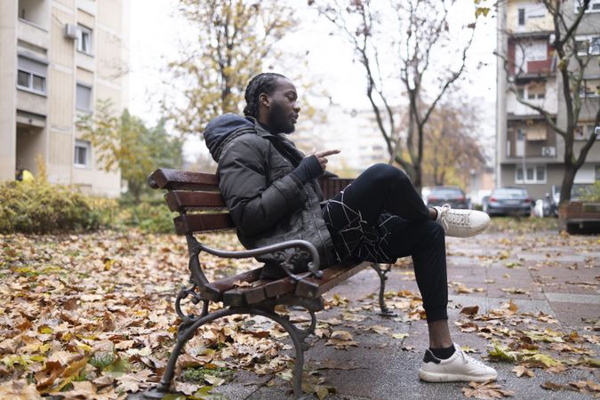 Young Black Man Explaining During a Video Call in the Park with a Laptop