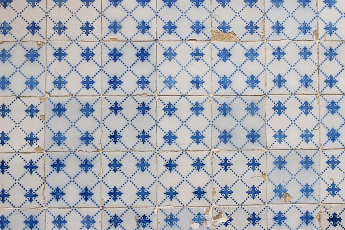 Simple blue traditional Portuguese ceramic tile pattern, azulejos, dots. Beautiful shabby dirty facade, wall decoration. Old Lisbon building, Portugal. Decorative background with geometric ornaments.