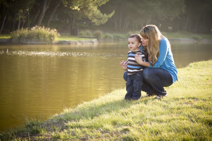 Happy Mother and Baby Son Looking Out At Lake