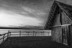 Monochrome shot of fishing hut at sunset
