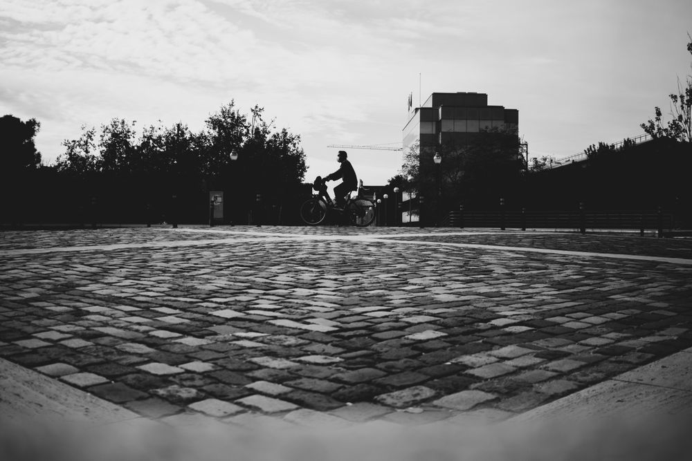 Grayscale photo of person on bicycle