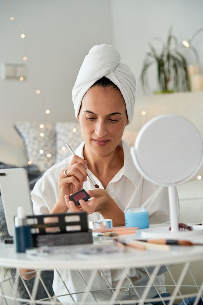 Female blogger testing eyeshadow on hand
