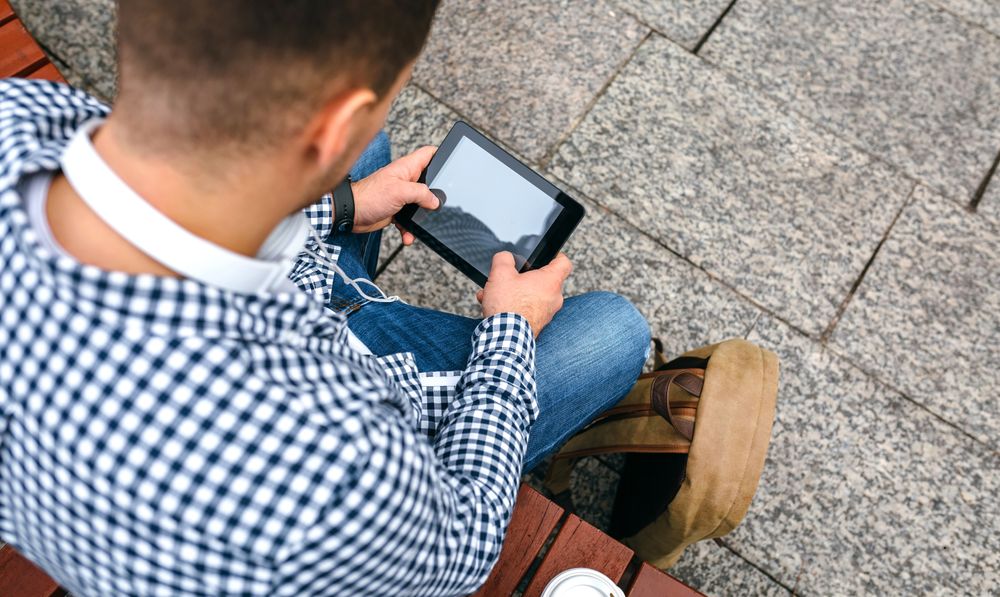 Unrecognizable man using tablet