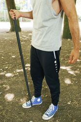 Sportsman stretching arms in park