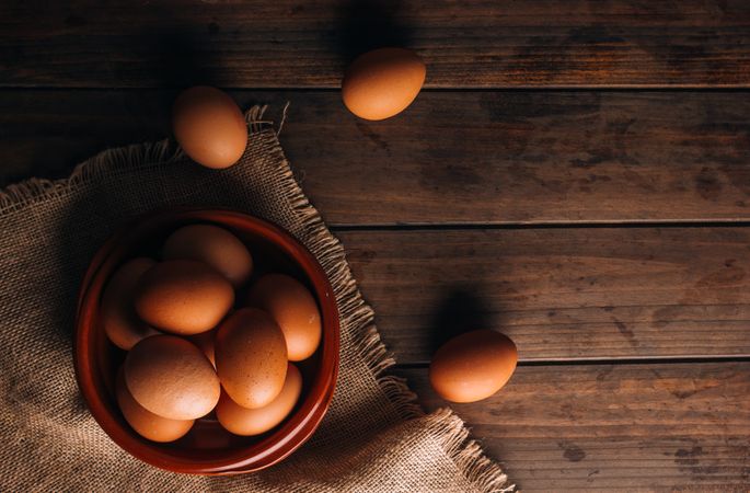Chicken eggs on napkin on wooden table