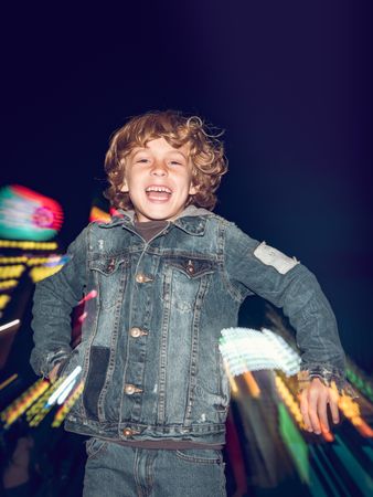 Gleeful boy jumping in amusement park