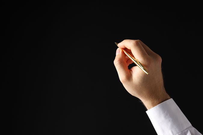 Businessman's hand close-up on a dark background