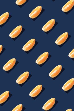 Pattern of orange fruit slices on navy background