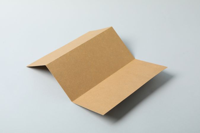 Empty craft cardboard on plain background, space for text