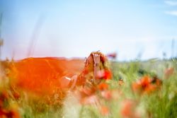 Young woman resting in blooming field