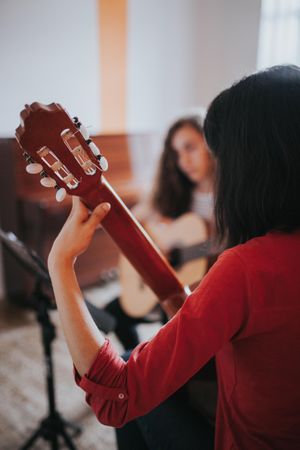 Close up of student with her hands on guitar