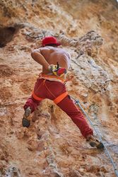 Anonymous mountaineer man climbing in mountains